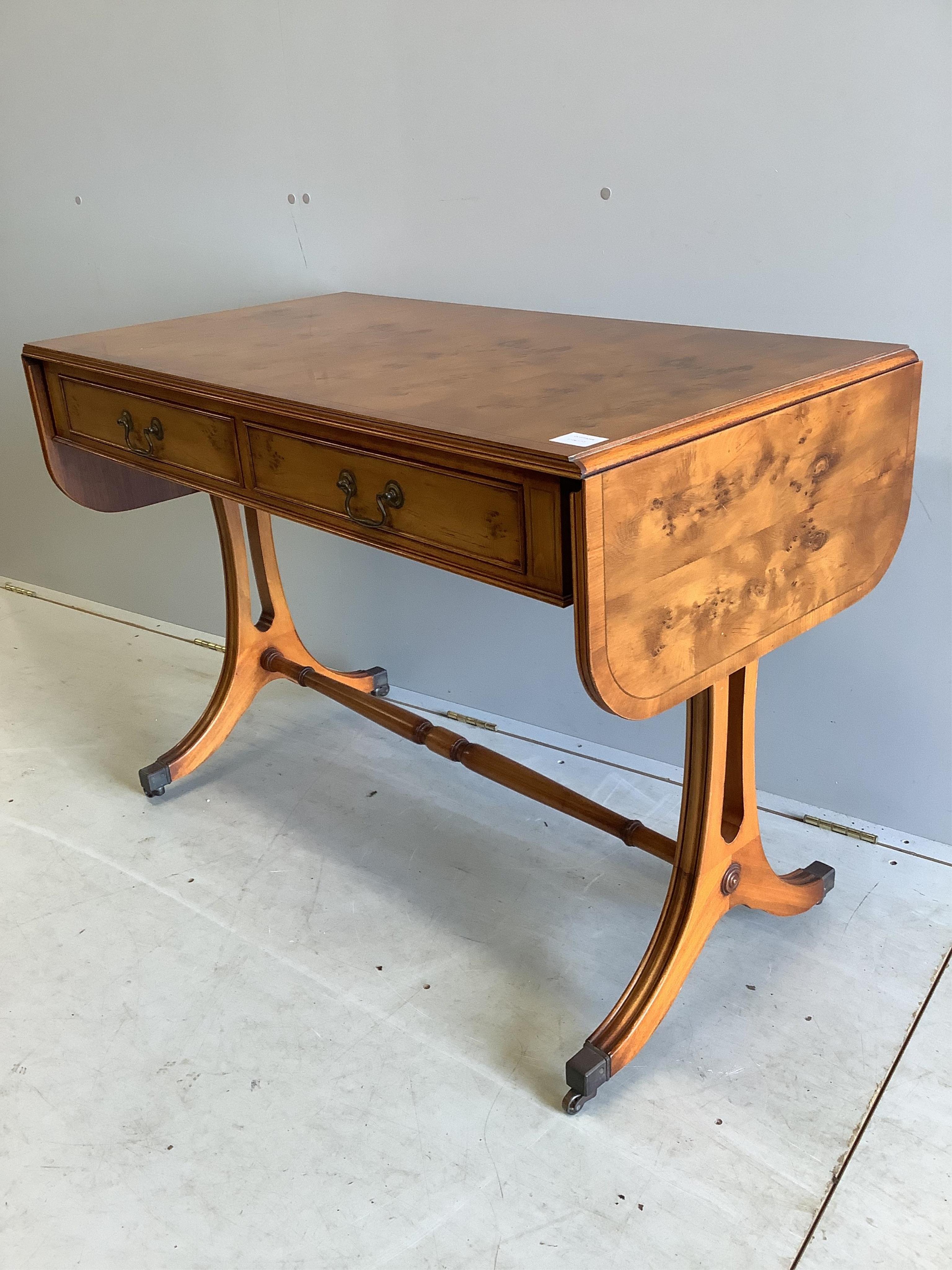 A reproduction Regency style yew sofa table, width 104cm, depth 56cm, height 74cm. Condition - good